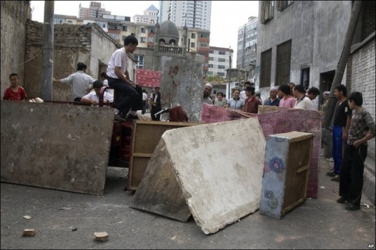 Uighur residents blocking off street